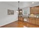 A charming eat-in kitchen with wood cabinets, granite counters, and a desk area at 4915 Bergen Ct, Cumming, GA 30040