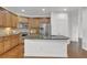 A modern kitchen with a large island, stainless steel appliances, and wood cabinets at 4915 Bergen Ct, Cumming, GA 30040