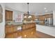 Well-equipped kitchen featuring wood cabinets, stainless steel appliances, and a center island with seating at 4915 Bergen Ct, Cumming, GA 30040