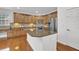 A spacious kitchen with an island, granite countertops, stainless steel appliances, and wood cabinets at 4915 Bergen Ct, Cumming, GA 30040