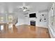 Open-concept living area featuring hardwood floors, a fireplace, and abundant natural light at 4915 Bergen Ct, Cumming, GA 30040
