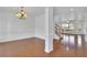 An open-concept living space with hardwood floors, white walls, and a staircase at 4915 Bergen Ct, Cumming, GA 30040