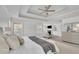 Spacious main bedroom features a trey ceiling, fan, sitting area and modern decor at 4915 Bergen Ct, Cumming, GA 30040