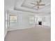 Bright main bedroom features carpet, neutral tones, a trey ceiling, and ample natural light at 4915 Bergen Ct, Cumming, GA 30040