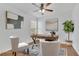 A bright office space with stylish decor, a ceiling fan, and hardwood floors at 4915 Bergen Ct, Cumming, GA 30040