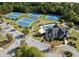 Aerial view of community pool, tennis courts, clubhouse, landscaping, and parking area surrounded by lush trees at 5280 Clingman Ct, Douglasville, GA 30135