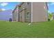 Spacious backyard featuring lush lawn, perfect for outdoor activities, with view of house siding at 5280 Clingman Ct, Douglasville, GA 30135