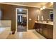 Open bathroom view with a double vanity and a glimpse into the bedroom at 5280 Clingman Ct, Douglasville, GA 30135