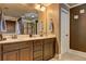 Bathroom with a double vanity, dark wood cabinets, and a large mirror at 5280 Clingman Ct, Douglasville, GA 30135