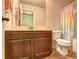 Well-lit bathroom featuring a wood vanity, modern fixtures, and a shower with a decorative curtain at 5280 Clingman Ct, Douglasville, GA 30135