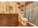 Well-lit bathroom featuring wooden floors and a shower with decorative curtains at 5280 Clingman Ct, Douglasville, GA 30135