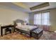 Cozy bedroom with a tray ceiling, a bed, and a window with curtains at 5280 Clingman Ct, Douglasville, GA 30135
