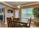 Cozy dining area with a wooden table, natural light, and views of the backyard at 5280 Clingman Ct, Douglasville, GA 30135