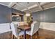 A formal dining area featuring a dark wooden table with upholstered chairs at 5280 Clingman Ct, Douglasville, GA 30135