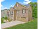 Beautiful two-story home featuring a brick and siding exterior, attached garage, and manicured landscaping at 5280 Clingman Ct, Douglasville, GA 30135