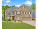 Charming brick home with a well-manicured lawn and a two-car garage at 5280 Clingman Ct, Douglasville, GA 30135