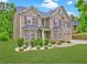 Beautiful shot of a traditional brick home with manicured landscaping, dormer window, and a two-car garage at 5280 Clingman Ct, Douglasville, GA 30135