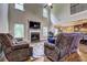 Open-concept living room with high ceilings, a fireplace, and an adjacent kitchen view at 5280 Clingman Ct, Douglasville, GA 30135