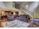 Spacious living room featuring hardwood floors, a staircase, and comfortable seating at 5280 Clingman Ct, Douglasville, GA 30135