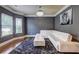 A living room with a gray accent wall, carpet, and an L-shaped white couch at 5280 Clingman Ct, Douglasville, GA 30135