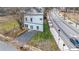 Modern two-story home with a sleek white exterior, gravel driveway, and minimal landscaping at 125 Laurel Sw Ave, Atlanta, GA 30314