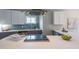Modern kitchen features gray cabinets, white countertops, stainless steel appliances, and a stylish tile backsplash at 125 Laurel Sw Ave, Atlanta, GA 30314