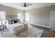 Bright main bedroom featuring a large window, ceiling fan, and a cozy rug at 125 Laurel Sw Ave, Atlanta, GA 30314