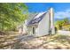 Exterior backyard featuring light green siding, a chimney, patio, and foliage at 432 Tanner Farm Dr, Rockmart, GA 30153
