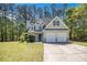 Charming two-story home with a well-manicured front yard and two-car garage at 432 Tanner Farm Dr, Rockmart, GA 30153