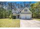 Charming two-story home featuring a two-car garage and a well-manicured lawn surrounded by mature trees at 432 Tanner Farm Dr, Rockmart, GA 30153