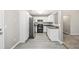 Well-lit kitchen features stainless steel appliances, white cabinetry and a laminate wood floor at 432 Tanner Farm Dr, Rockmart, GA 30153