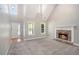 Sunlit living room showcases vaulted ceilings, large windows, and stone fireplace, creating an inviting atmosphere at 432 Tanner Farm Dr, Rockmart, GA 30153