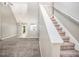 Spacious living room with staircase features carpeted floors, an open concept design and lots of natural light at 432 Tanner Farm Dr, Rockmart, GA 30153
