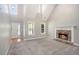 Bright living room with vaulted ceilings, a stone fireplace, plush carpeting, and abundant natural light at 432 Tanner Farm Dr, Rockmart, GA 30153