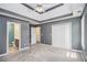 Spacious main bedroom featuring a tray ceiling, a ceiling fan, and large closet space at 432 Tanner Farm Dr, Rockmart, GA 30153