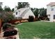 A large, well-manicured backyard includes a dark wood fence, lush landscaping and an outdoor fire pit at 4406 Dickens Nw Ct, Kennesaw, GA 30144