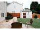 Inviting backyard featuring a cozy firepit, a well-maintained lawn, and a charming storage shed at 4406 Dickens Nw Ct, Kennesaw, GA 30144