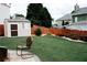 Lush backyard with a manicured lawn, a wooden shed, and a patio area perfect for outdoor enjoyment at 4406 Dickens Nw Ct, Kennesaw, GA 30144