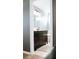 Modern bathroom with a dark vanity and marble counters, complete with a tub in the background at 4406 Dickens Nw Ct, Kennesaw, GA 30144