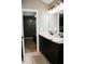 This bathroom features a double sink with dark cabinets and granite countertops at 4406 Dickens Nw Ct, Kennesaw, GA 30144