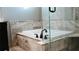 Bathroom featuring a tiled soaking tub and glass shower door at 4406 Dickens Nw Ct, Kennesaw, GA 30144