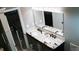 Bathroom featuring a dual sink vanity with granite countertop and large mirror at 4406 Dickens Nw Ct, Kennesaw, GA 30144