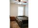Cozy bedroom featuring a ceiling fan, large window, and neutral colored walls at 4406 Dickens Nw Ct, Kennesaw, GA 30144
