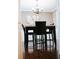 A cozy dining area with hardwood floors and a modern chandelier at 4406 Dickens Nw Ct, Kennesaw, GA 30144