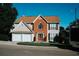 Traditional two-story home features a brick facade, a two-car garage, and a well-manicured lawn at 4406 Dickens Nw Ct, Kennesaw, GA 30144