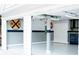 Garage featuring storage cabinets, epoxy flooring, and tool chest at 4406 Dickens Nw Ct, Kennesaw, GA 30144