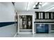 Well-organized garage with blue tool chest, overhead storage, and a utility closet for essential systems at 4406 Dickens Nw Ct, Kennesaw, GA 30144