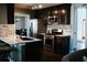 Gourmet kitchen features granite counters, stainless steel appliances and dark wood cabinetry at 4406 Dickens Nw Ct, Kennesaw, GA 30144