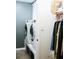 Bright laundry room with white appliances including a front loading washer and dryer at 4406 Dickens Nw Ct, Kennesaw, GA 30144