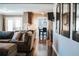 Open concept living room showcasing the kitchen and dining area, with hardwood floors and natural light at 4406 Dickens Nw Ct, Kennesaw, GA 30144